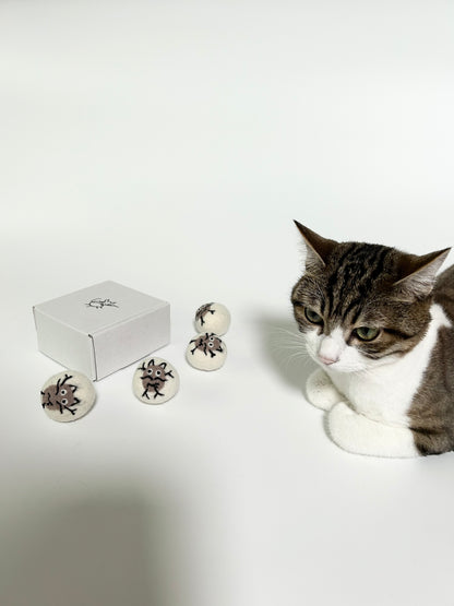Indoor cat playing with Potato Meow handmade felt toy balls