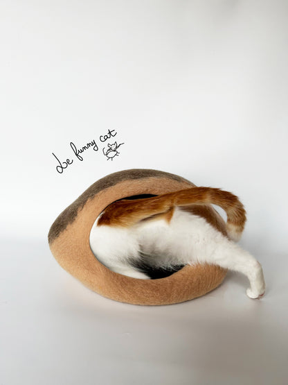 Cat relaxing inside the A Chestnut handmade felt cat cave