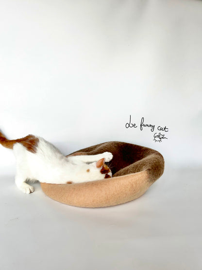 Cat relaxing inside the A Chestnut handmade felt cat cave