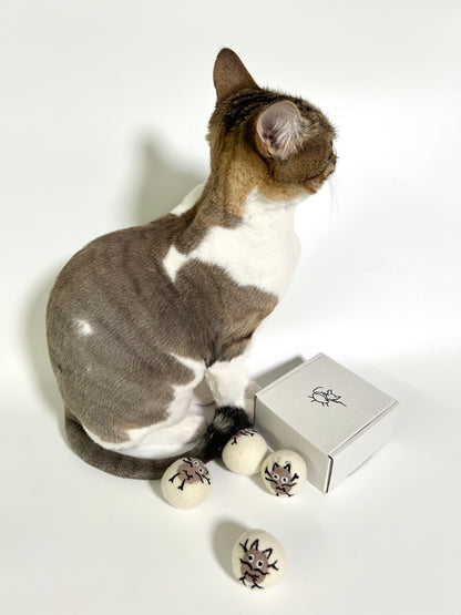 Indoor cat playing with Potato Meow handmade felt toy balls
