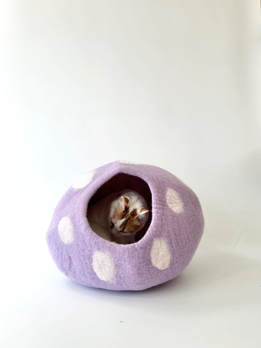 Cat resting inside the handmade Taro Bobo felt cat cave