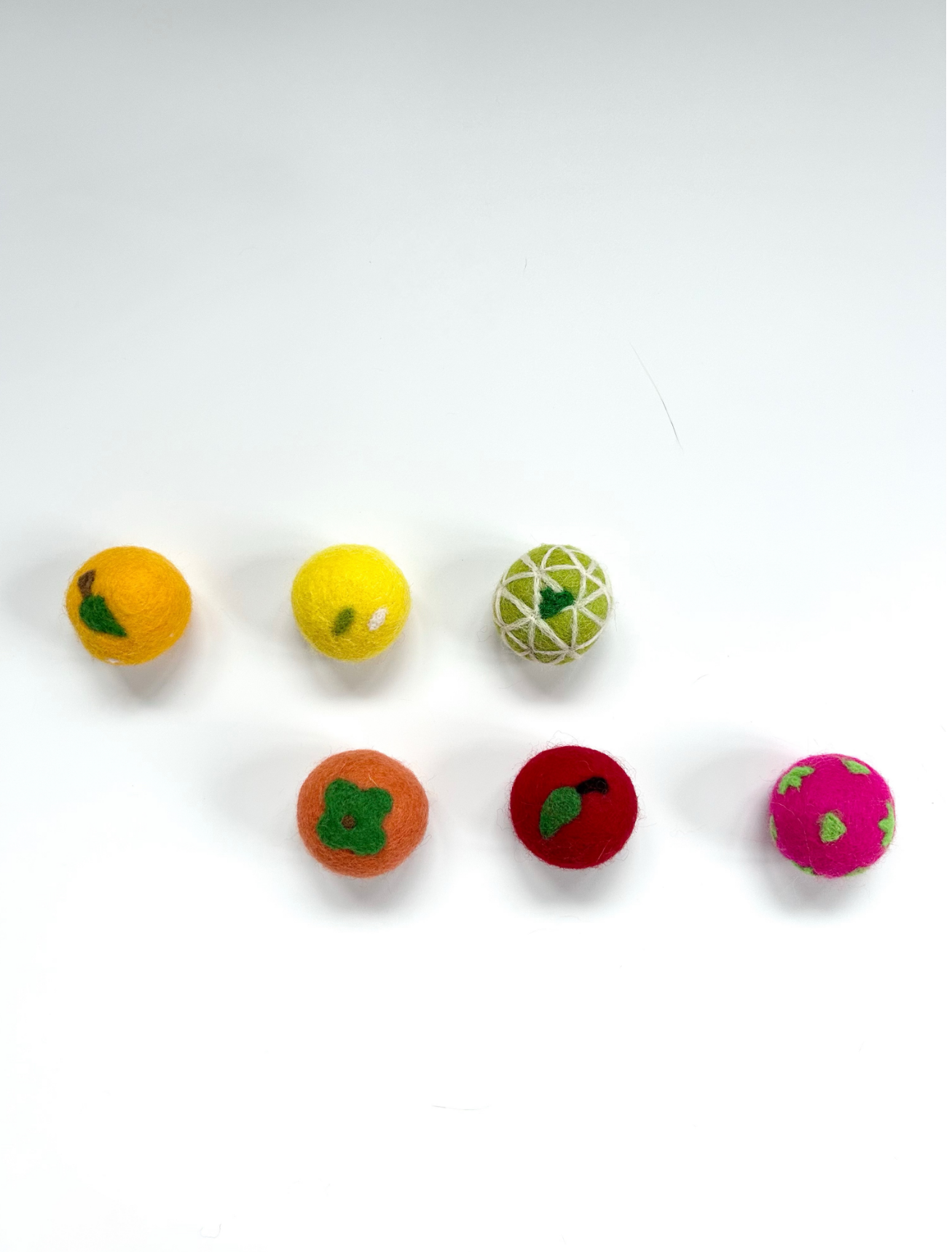 Close-up of the premium wool felt used in the Fortune Fruit Box cat balls
