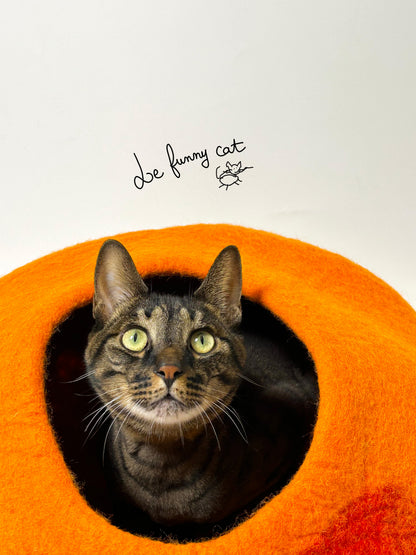 Cat relaxing inside the Warm Sunset handmade felt cat cave