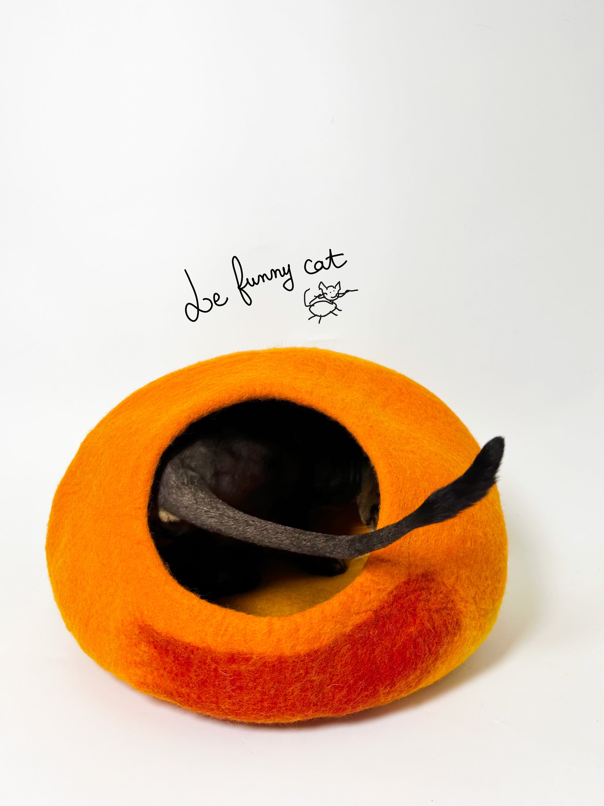 Cat relaxing inside the Warm Sunset handmade felt cat cave